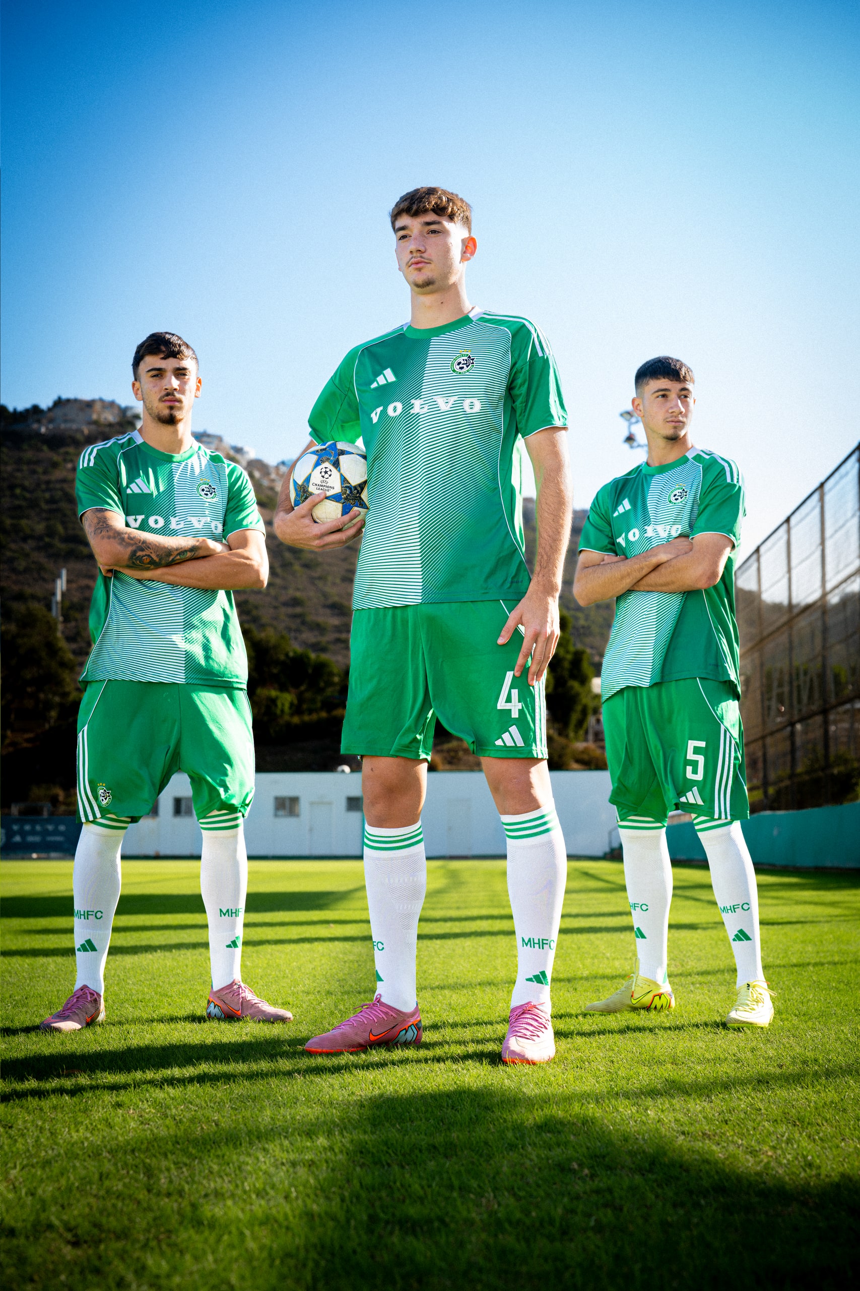 Three Maccabi Haifa players on the pitch with the Champions League ball